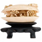 Carved Ivory Clam Shell On wooden Stand. Click for more information...